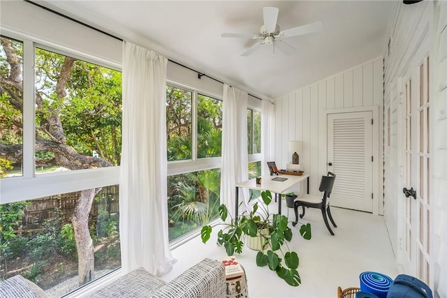 sunroom with a ceiling fan and lofted ceiling