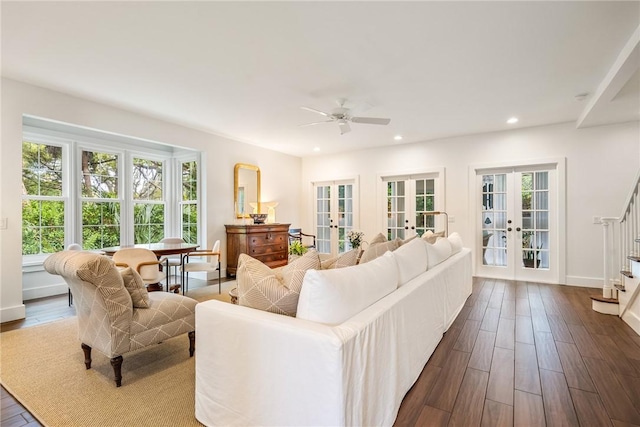 living area featuring dark wood-type flooring, recessed lighting, french doors, baseboards, and stairs