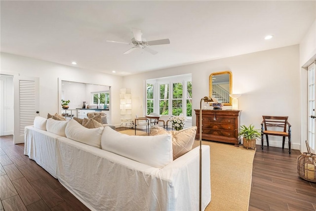 living area with dark wood finished floors, recessed lighting, stairway, baseboards, and ceiling fan