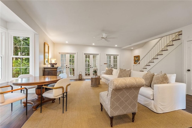 living area with wood finished floors, recessed lighting, and french doors