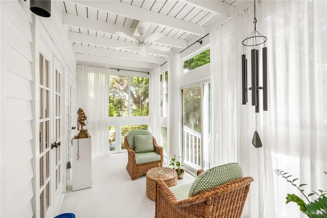 sunroom / solarium featuring beam ceiling, wood ceiling, and a ceiling fan