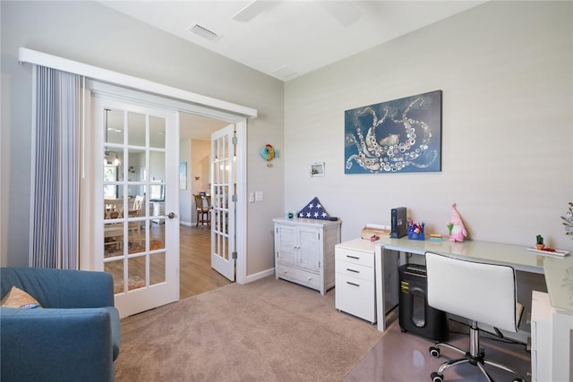 office area with baseboards, visible vents, light colored carpet, ceiling fan, and french doors