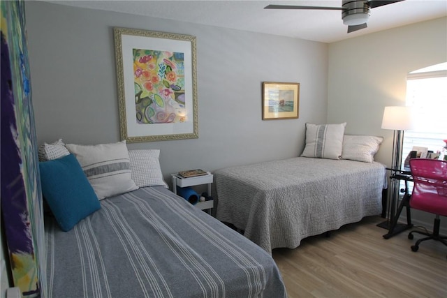 bedroom with a ceiling fan and wood finished floors