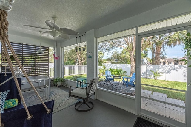 unfurnished sunroom with ceiling fan and a healthy amount of sunlight