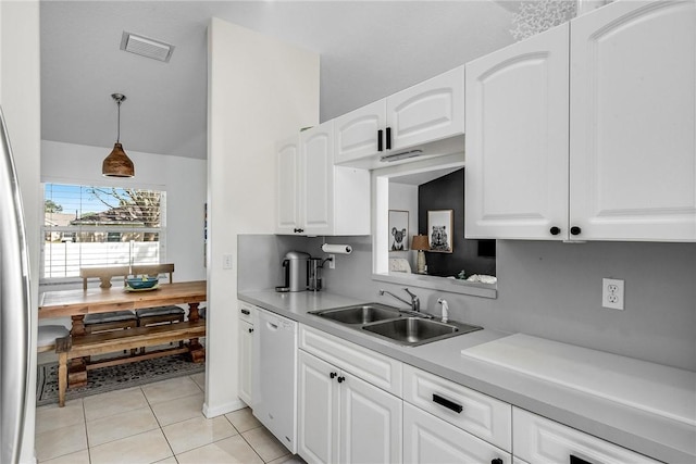 kitchen with dishwasher, light countertops, a sink, and white cabinets