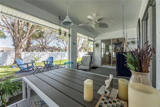 view of patio with outdoor dining space, a fenced backyard, and ceiling fan