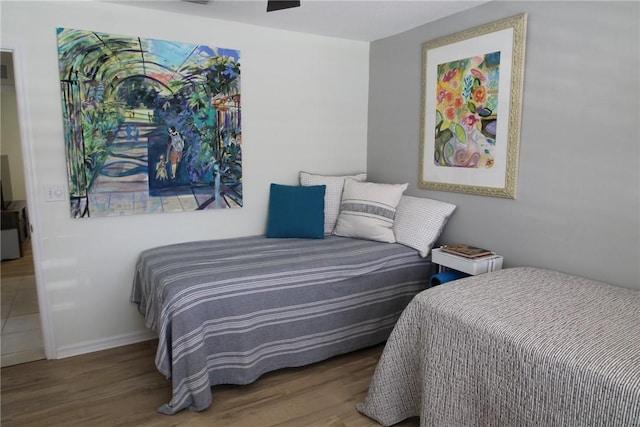 bedroom with baseboards and wood finished floors