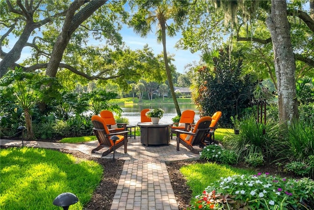 view of patio / terrace featuring a water view and an outdoor fire pit