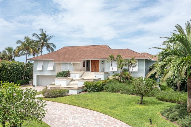 view of front of property with a front lawn and a garage