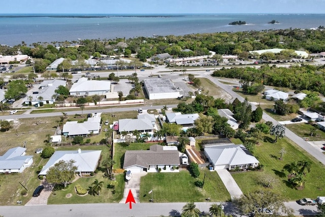 birds eye view of property with a water view and a residential view