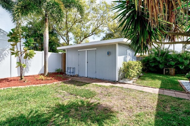 view of shed featuring fence