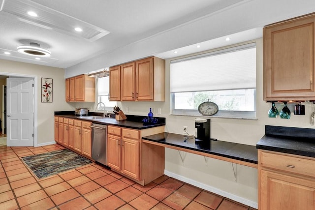 kitchen with dark countertops, a sink, dishwasher, and light tile patterned floors