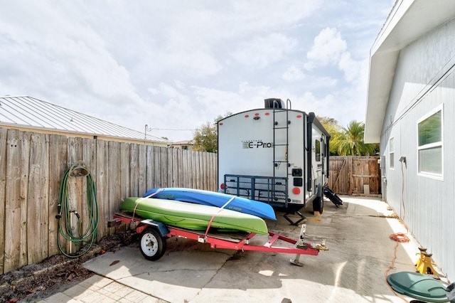 view of parking with a fenced backyard