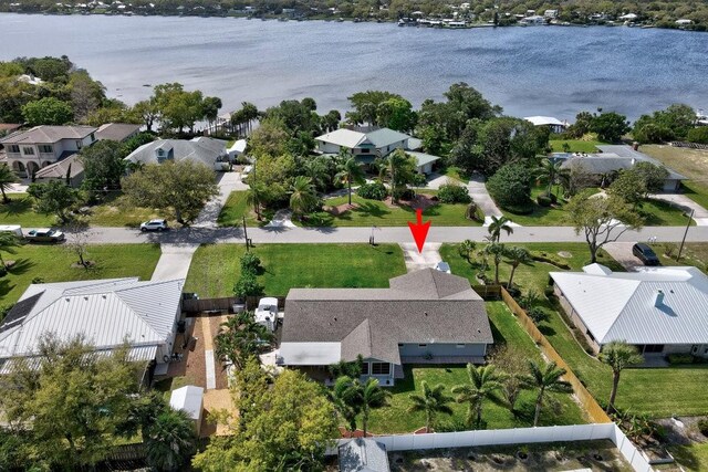 birds eye view of property featuring a water view and a residential view