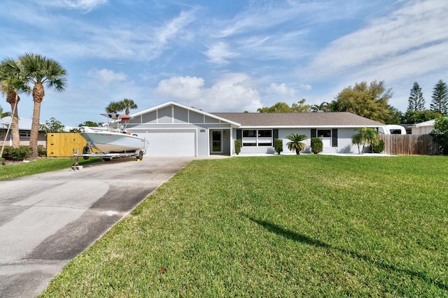 ranch-style home with an attached garage, driveway, fence, and a front yard