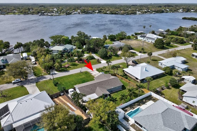 drone / aerial view with a residential view and a water view