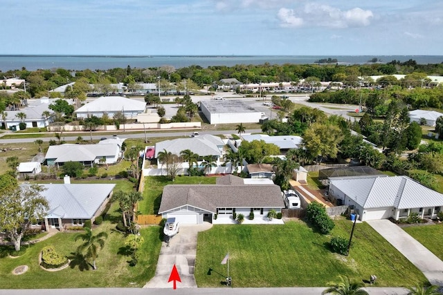 drone / aerial view with a water view and a residential view