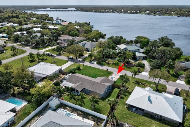 birds eye view of property featuring a water view and a residential view