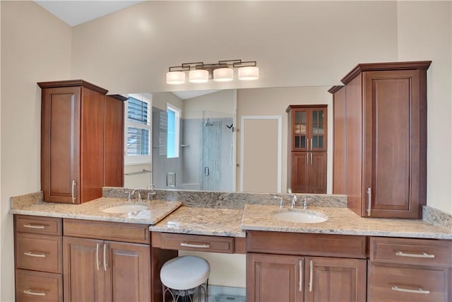 bathroom with vanity and a shower with shower door