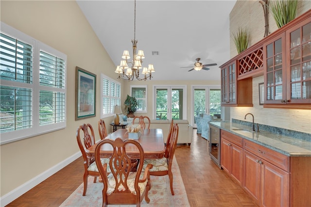 dining area with light parquet floors, plenty of natural light, sink, and wine cooler