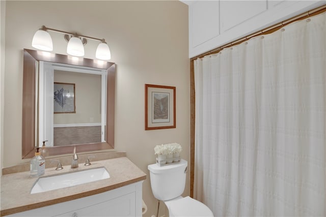 bathroom with vanity, walk in shower, and toilet