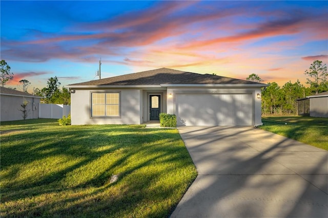 ranch-style house with a lawn and a garage