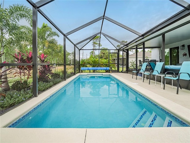 outdoor pool featuring a lanai and a patio