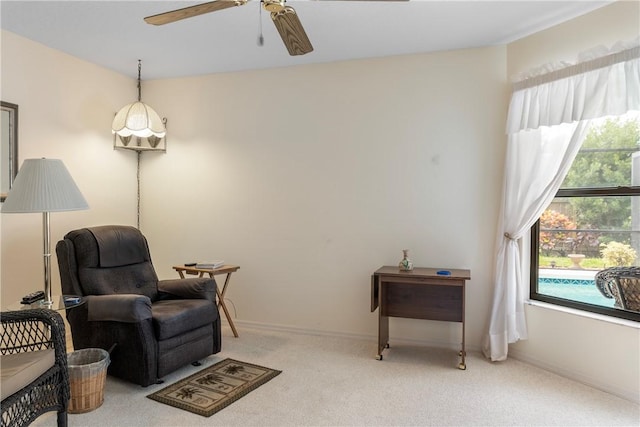 living area featuring ceiling fan and carpet floors