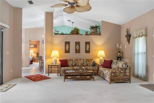 living room with ceiling fan, light carpet, and vaulted ceiling