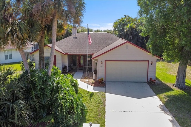 view of front of house featuring a garage and a front lawn