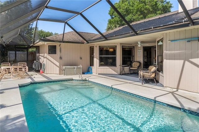 view of swimming pool with a lanai, ceiling fan, and a patio area