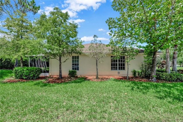 back of property featuring a lawn