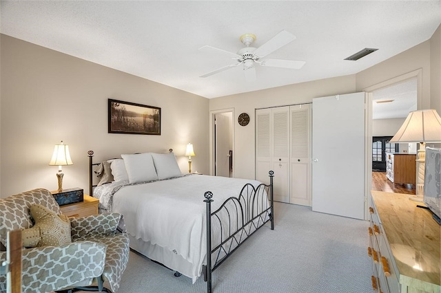 carpeted bedroom with a closet and ceiling fan