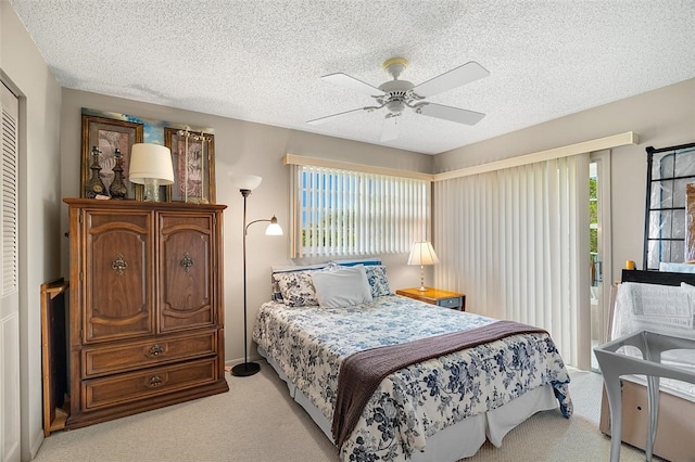 carpeted bedroom featuring multiple windows, ceiling fan, access to exterior, and a textured ceiling