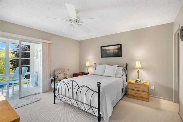 carpeted bedroom featuring ceiling fan, access to outside, and a textured ceiling