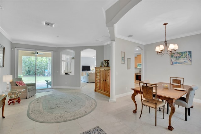 tiled dining space featuring an inviting chandelier and ornamental molding