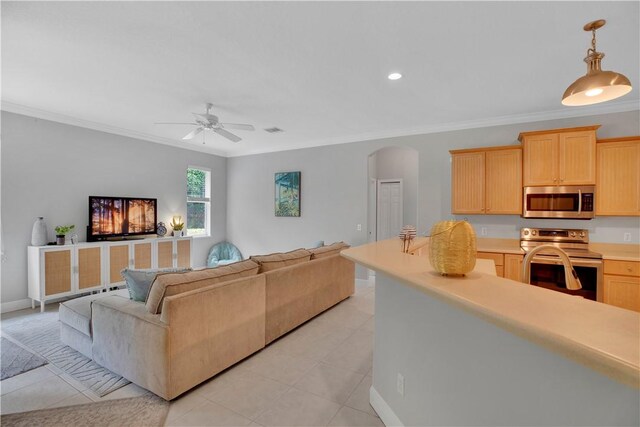 6770 49th Ct, Vero Beach, FL 32967 - living area with crown molding, ceiling fan, arched walkways, light tile patterned floors, and recessed lighting