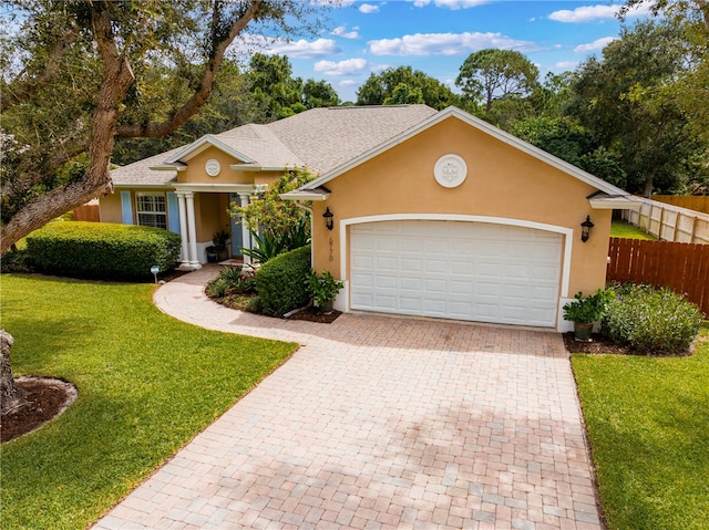 single story home featuring a garage and a front lawn