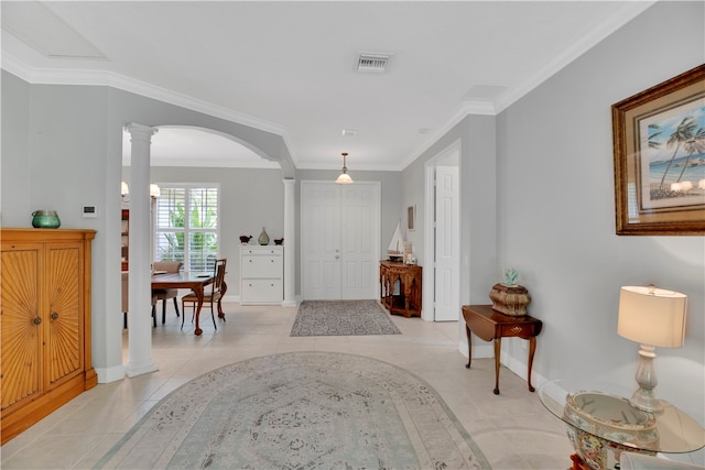 tiled entrance foyer featuring ornate columns and ornamental molding