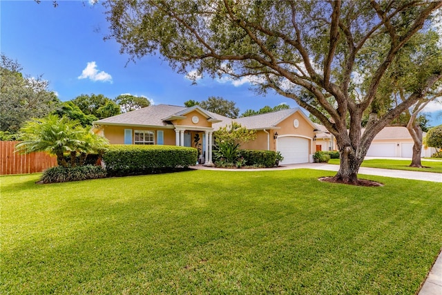 ranch-style home featuring a garage and a front lawn