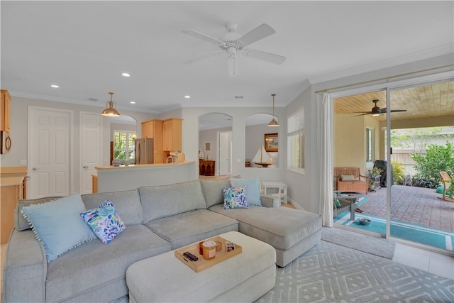 tiled living room featuring ornamental molding and ceiling fan