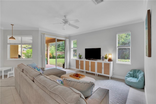 tiled living room featuring a wealth of natural light, ceiling fan, and ornamental molding