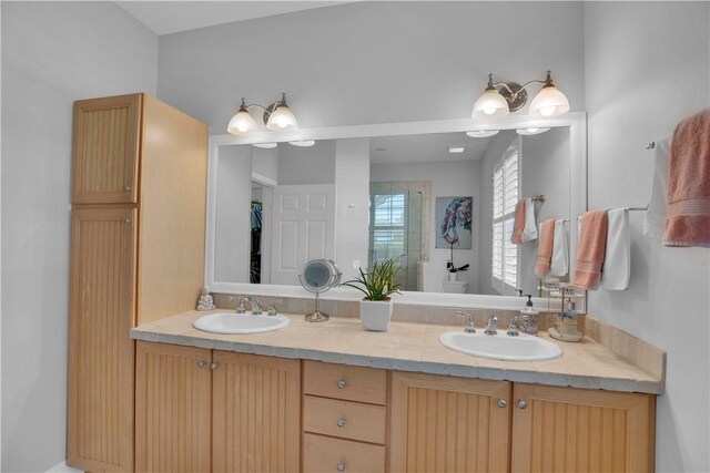 6770 49th Ct, Vero Beach, FL 32967 - bathroom with double vanity and a shower with door