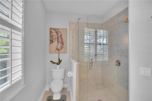 bathroom with a shower with shower door, tile patterned floors, and toilet