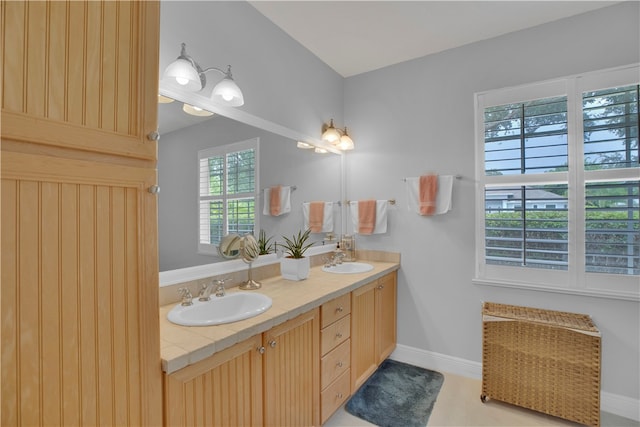 bathroom featuring tile patterned flooring and vanity