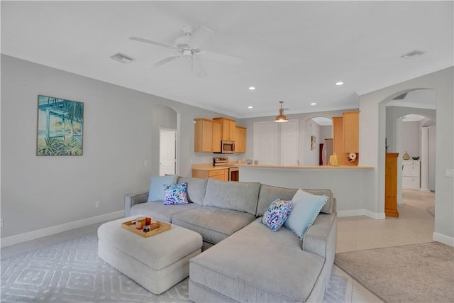 6770 49th Ct, Vero Beach, FL 32967 - living area featuring ceiling fan, arched walkways, baseboards, recessed lighting, and crown molding