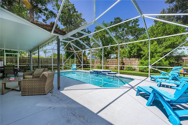 view of swimming pool featuring a lanai, a patio, and a jacuzzi