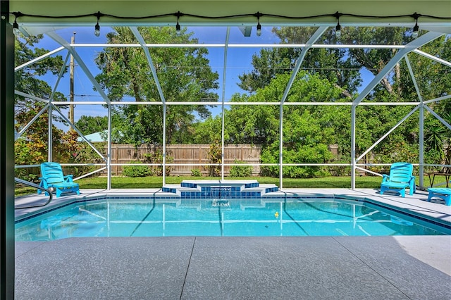 view of swimming pool featuring a patio area, a jacuzzi, and a lanai