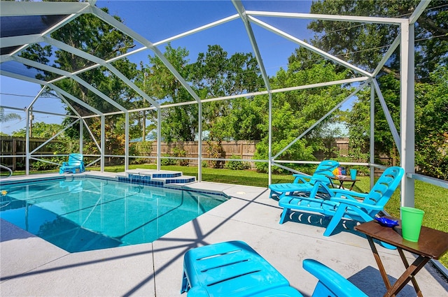 view of swimming pool with glass enclosure, a jacuzzi, and a patio area