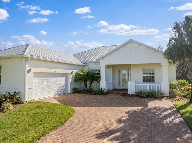 view of front of property featuring covered porch and a garage